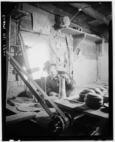 Potter trimming a tall vessel, Evans Pottery, Dexter, Stoddard County, Missouri (HABS view 3)